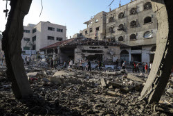 Palestinians inspect destroyed building after Israeli airstrike in Gaza City