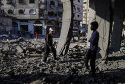 Palestinians inspect destroyed building after Israeli airstrike in Gaza City