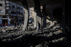 Palestinians inspect destroyed building after Israeli airstrike in Gaza City