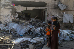 Palestinians inspect destroyed building after Israeli airstrike in Gaza City