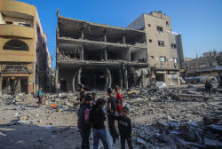 Palestinians inspect destroyed building after Israeli airstrike in Gaza City