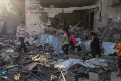 Palestinians inspect destroyed building after Israeli airstrike in Gaza City