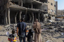 Palestinians inspect destroyed building after Israeli airstrike in Gaza City