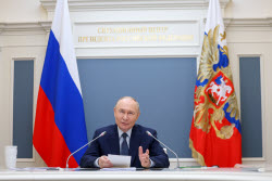 Russia's President Putin meets with families awarded Orders of Parental Glory