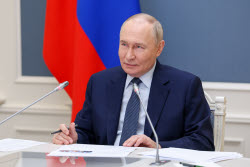 Russia's President Putin meets with families awarded Orders of Parental Glory
