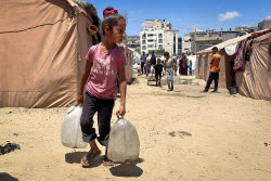 Palestinians try to meet their daily water needs by filling jerry cans with water distributed by tankers as the 'humanitarian crisis' in the region continues to deepen due to the total embargo