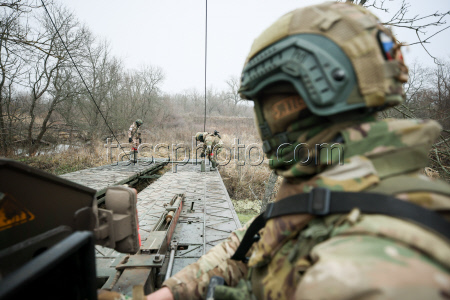 Russian troops build bridge crossing in special military operation zone