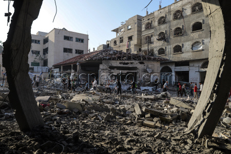 Palestinians inspect destroyed building after Israeli airstrike in Gaza City