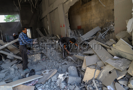 Palestinians inspect destroyed building after Israeli airstrike in Gaza City