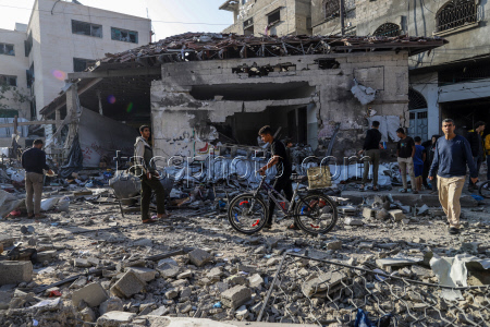 Palestinians inspect destroyed building after Israeli airstrike in Gaza City