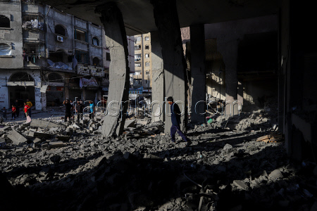 Palestinians inspect destroyed building after Israeli airstrike in Gaza City