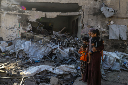 Palestinians inspect destroyed building after Israeli airstrike in Gaza City