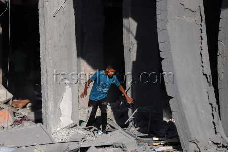 Palestinians inspect destroyed building after Israeli airstrike in Gaza City